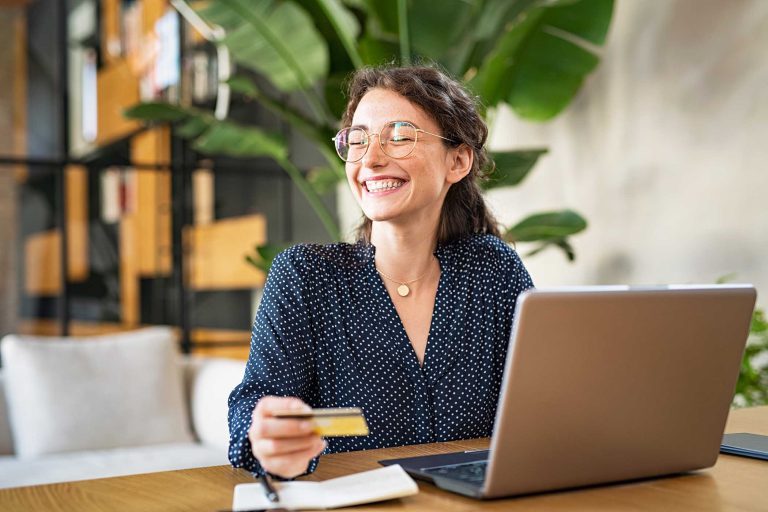 woman-with-laptop-using-credit-card-DZ35VKV.jpg